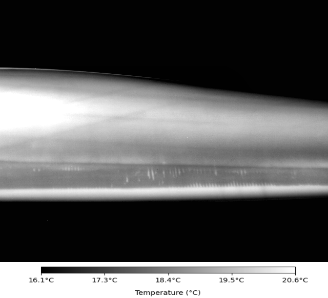 Thermographic image of a rotor blade in operation with visible defects in the internal bonding between the web and the shell.