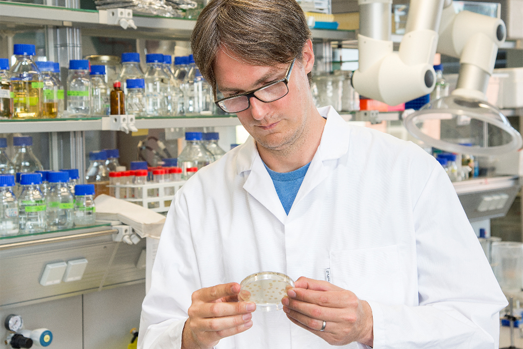 Dr. Frank Schreiber with bacterial cultures Dr. Frank Schreiber with bacterial cultures