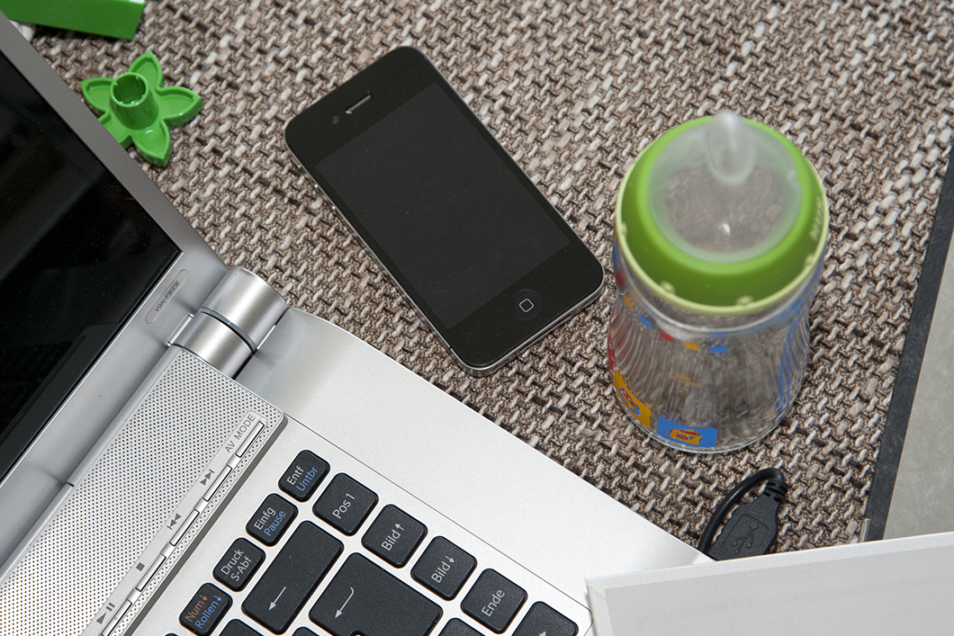 Laptop, smartphone and baby bottle