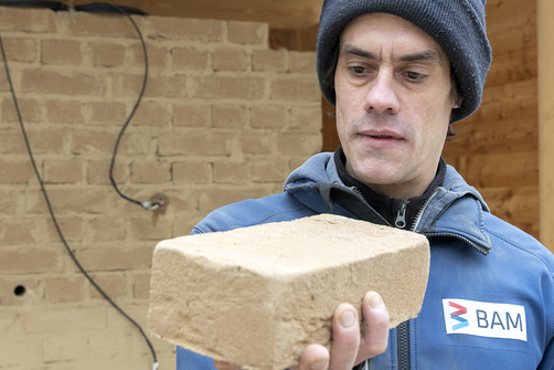 Philipp Wiehle with an earth brick