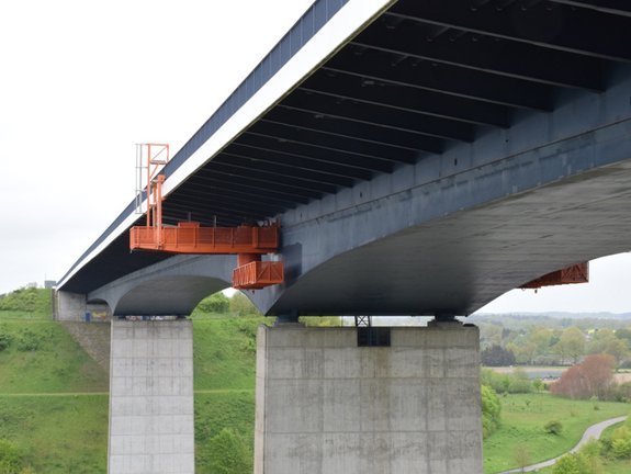 A concrete bridge with a maintenance platform installed below.