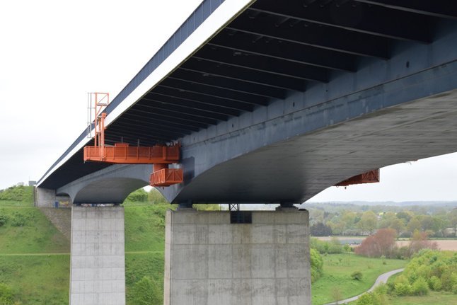 Eine Betonbr&uuml;cke mit einer unten angebrachten Wartungsplattform.