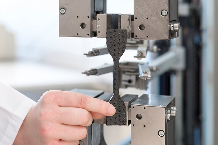 Tensile testing of structured geomembranes