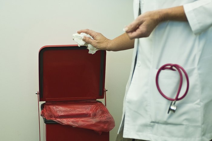 Discarding waste in medical waste bin